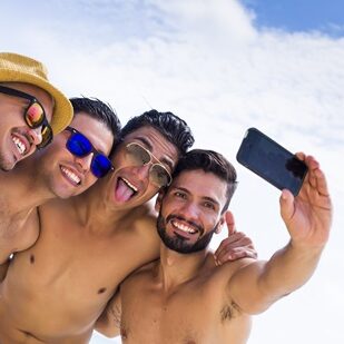 Group,Of,Four,Male,Friend,Taking,A,Selfie,At,The